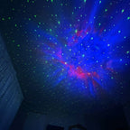 blue and red nebula and stars display projected onto dark ceiling
