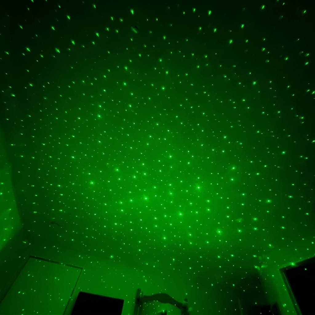 Projector display of green stars on ceiling